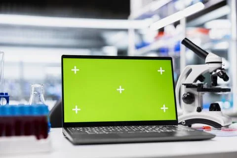 Green screen laptop in empty laboratory used for DNA data analysis Stock Photos