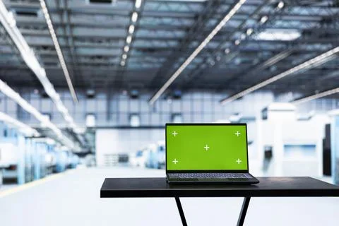Green screen laptop in empty microchip factory used for testing silicon wafers Stock Photos