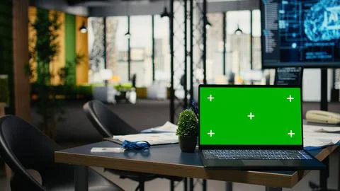 Green screen laptop in empty office used to accelerate AI calculations Stock Photos