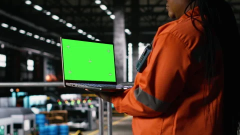 Green screen laptop held by black woman engineer in industrial factory Stock Footage 330205007