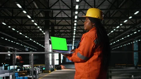 Green screen laptop held by black woman engineer in industrial factory Stock Footage 330442402