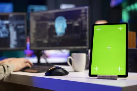 Green screen laptop next to programmer in home office staggered by sentient AI Stock Photos