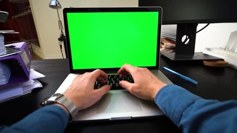 Green screen laptop or notebook. Man in watch and blue shirt typing on the Stock Footage 120656723