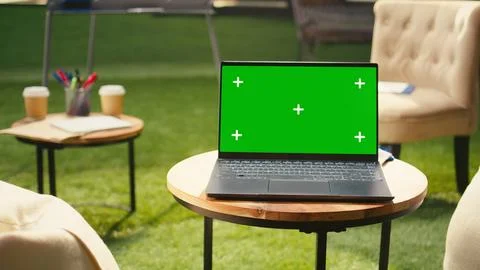 Green screen laptop placed on table in empty office terrace modern workspace Stockfoto's