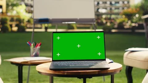 Green screen laptop placed on table in empty office terrace modern workspace Stockfoto's