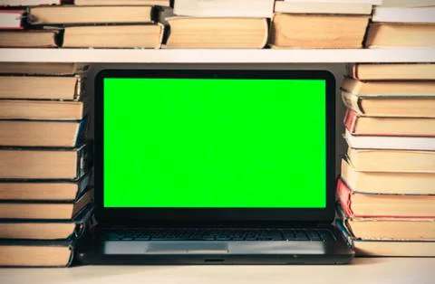 Green screen laptop, stack of books, notebook and pencils on white table, edu Stock Photos