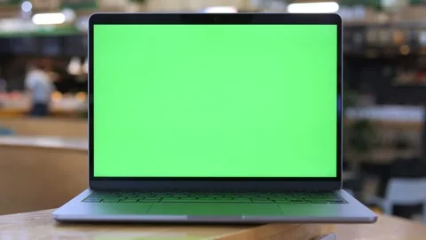 Green screen laptop on table in cafe setting Stock Footage 340914139