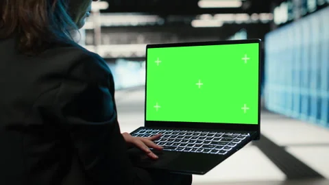 Green screen laptop used by data center programmer to troubleshoot issues Stock Footage 329324946