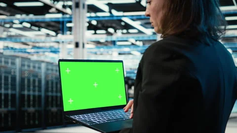 Green screen laptop used by data center developer to monitor industrial systems Stock Footage 329331048