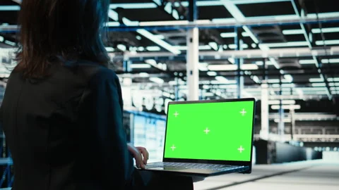 Green screen laptop used by data center programmer to troubleshoot issues Stock Footage 329331645