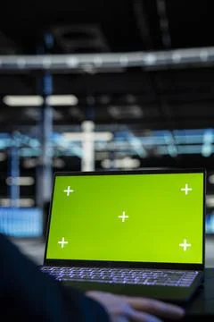 Green screen laptop used by data center admin to inspect infrastructure Stock Photos