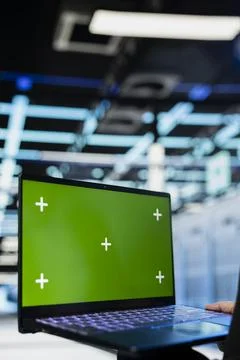 Green screen laptop used by data center engineer to review equipment diagnostics Stock Photos