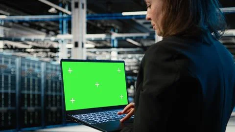Green screen laptop used by data center developer to monitor industrial systems Stock Photos