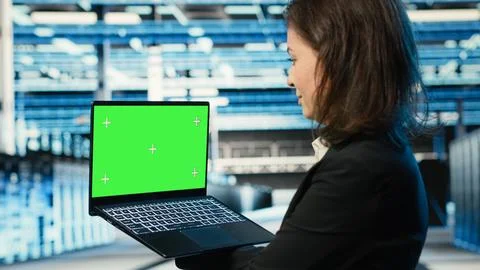 Green screen laptop used by data center developer to monitor industrial systems Stock Photos