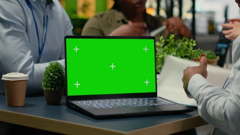 Green screen laptop used by programmers in startup office leveraging AI tech Stock Footage 323030377
