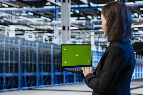 Green screen laptop used by server farm admin, AR visualization graphics Stock Photos