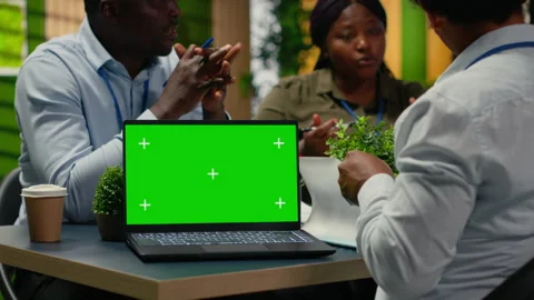 Green screen laptop used by tech startup office programmers doing meeting Stock Footage 322698890