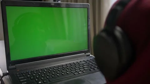 Green screen laptop view from behind a child wearing headphone Stock Footage 163259078