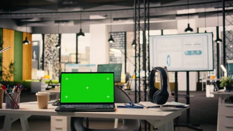 Green screen laptop at workstation in empty bright open office Stock Footage 329328960