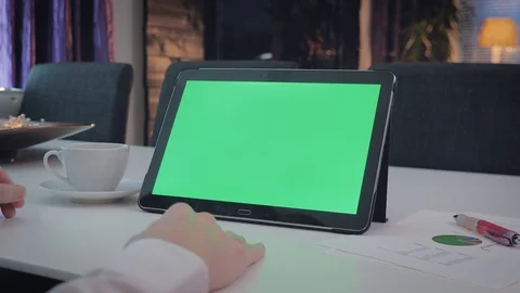 GREEN SCREEN man locking on his tablet pc Stock Footage 98213646