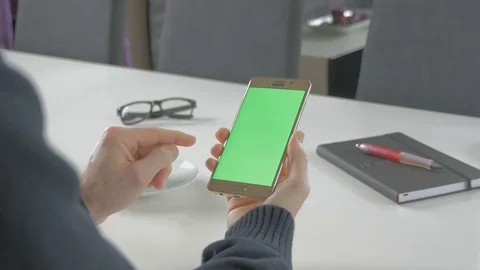 GREEN SCREEN man watching on his mobile phone Stock Footage 83221123