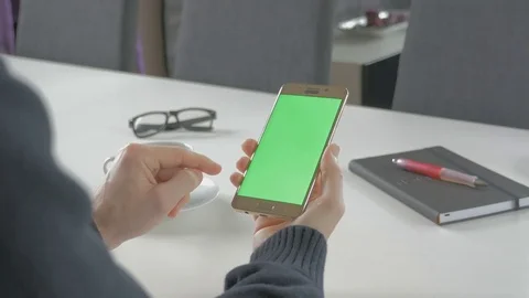 GREEN SCREEN man watching on his mobile phone Stock Footage 83221288
