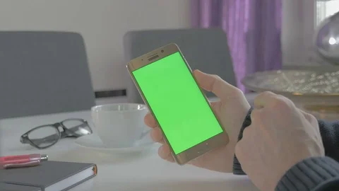 GREEN SCREEN man watching on his mobile phone Stock Footage 83221981