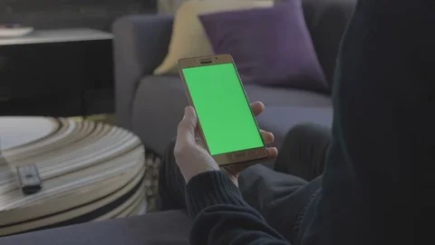 GREEN SCREEN man watching on his mobile phone Stock Footage 83486730