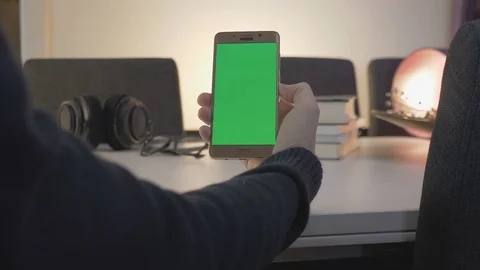 GREEN SCREEN man watching on his mobile phone Stock Footage 83486939