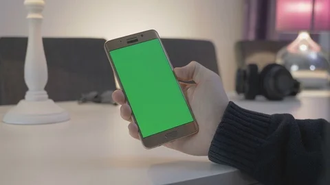 GREEN SCREEN man watching on his mobile phone Stock Footage 83487030