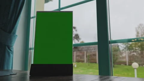 Green screen menu holder placed on a restaurant table, perfect for showcasing Video stock 347462333