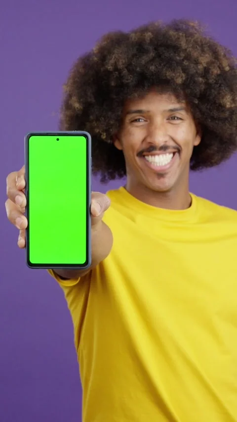 Green screen of the mobile held by an african man Stock Footage 245073516