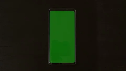 Green Screen Mobile Phone on Flat Black Background, Chromakey Stock Footage 127986149