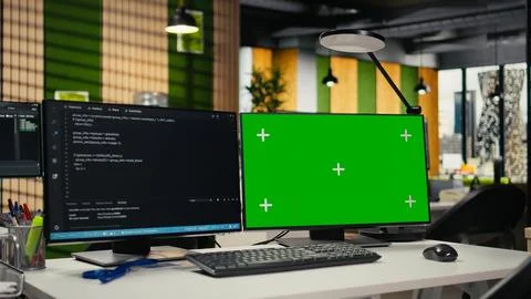 Green screen mockup computer monitors in empty startup workspace Stock-Fotos