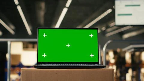 Green screen mockup on laptop in empty distribution center facility Fotos Stock