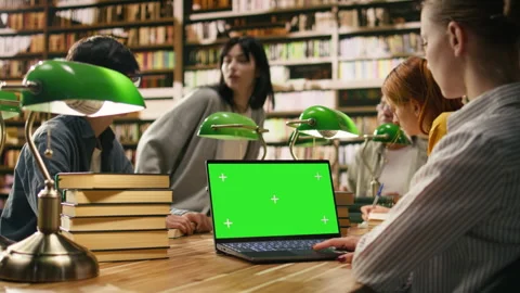 Green screen mockup on laptop inside university library desk Stock Footage 336359432