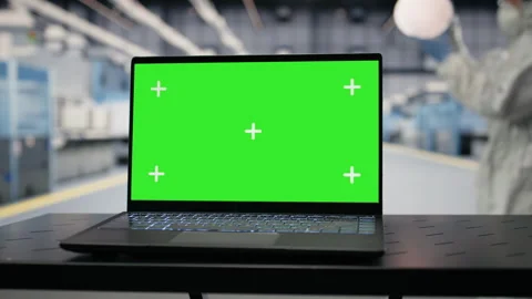 Green screen mockup laptop used by engineer in semiconductor factory Stock Footage 333391848