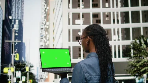 Green screen mockup laptop used by black woman walking, composing emails Stock Footage 334168879