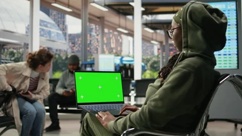 Green screen mockup notebook used by traveler in bus terminal Stock Footage 341972422