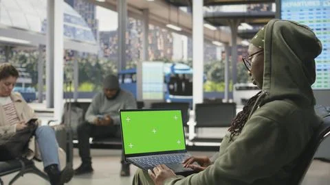 Green screen mockup notebook used by woman working in bus station Stock Photos