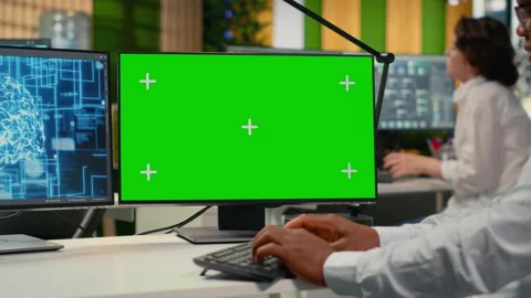 Green screen mockup PC used by data scientist in office automating with AI Stock Footage 323143502