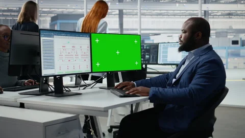 Green screen mockup PC used by man in semiconductors factory office Stock Footage 335880406