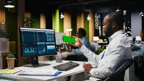 Green screen mockup screen on mobile phone held by a general manager Stock Photos
