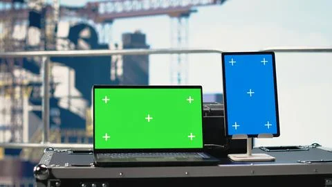 Green screen mockup tablet and laptop on offshore platform deck Stock Photos