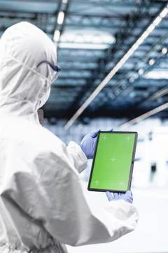 Green screen mockup tablet used by man in microchip industrial plant Stock Photos