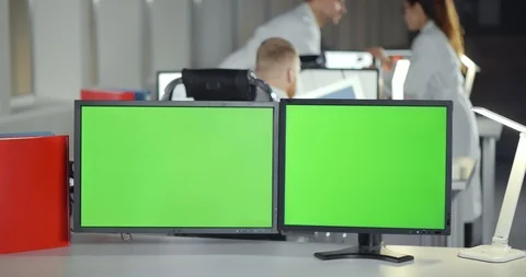 Green screen monitors in busy engineering department office Stock Footage 126640094