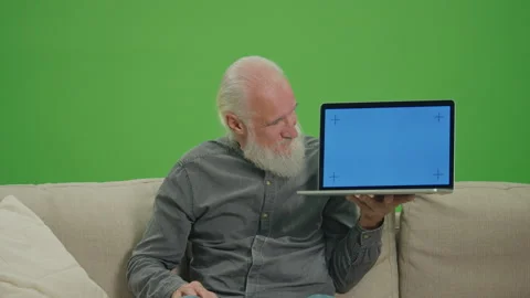 Green Screen.An Old Man with a Laptop with Blue Screen Shows Thumb Up. Video stock 263396013