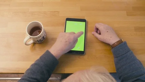 Green screen. Old woman scrolling the tablet Stock Footage