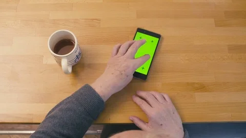 Green screen. Old woman scrolling smartphone Stock Footage