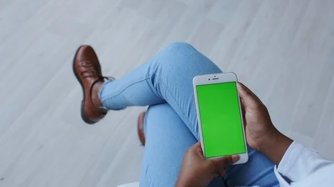 Green Screen or Mock-up Tracking. Afro Dark-skinned Girl Using Smartphone at Stock Footage 121090781